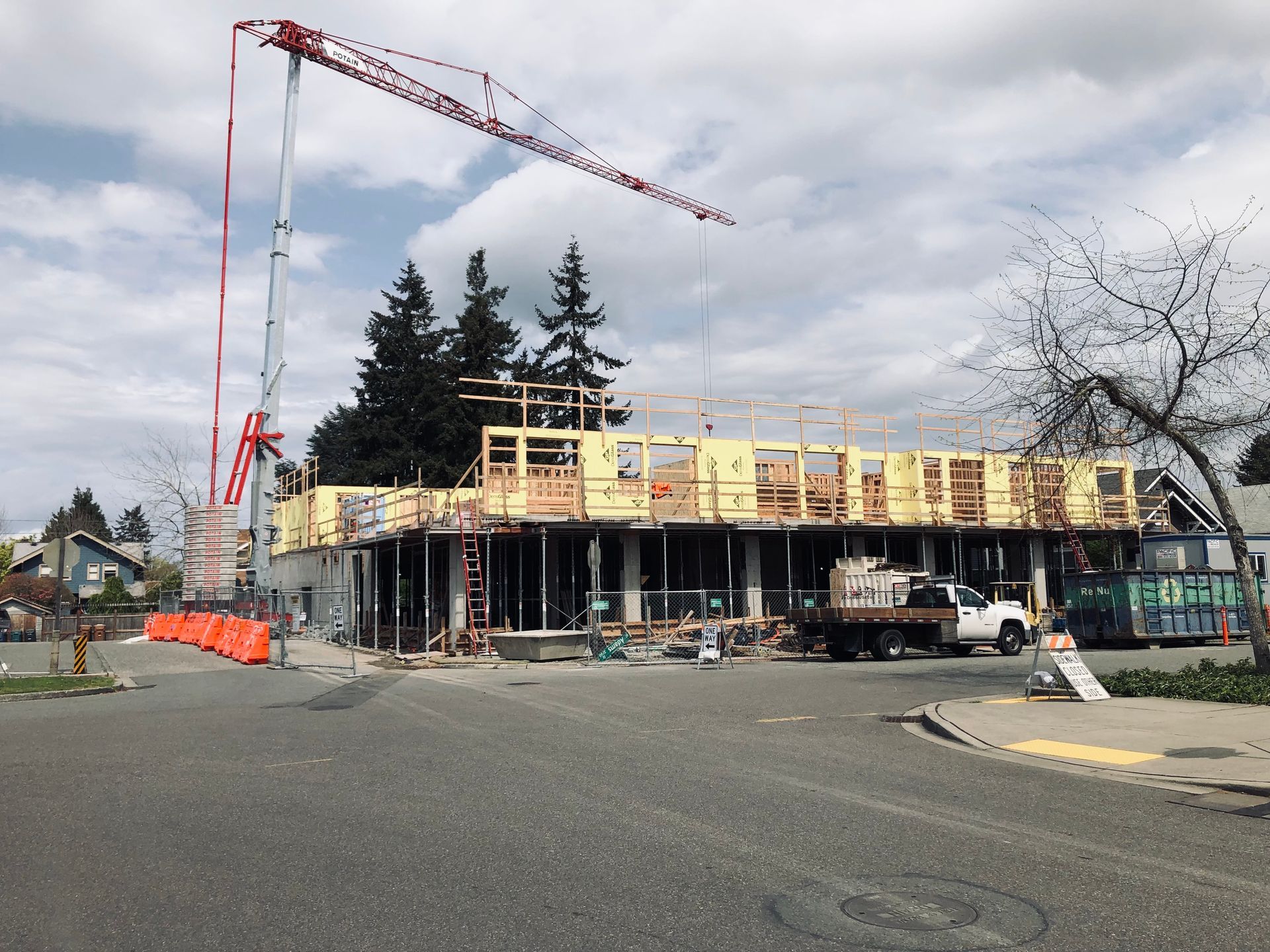 A large building under construction with a crane in the background