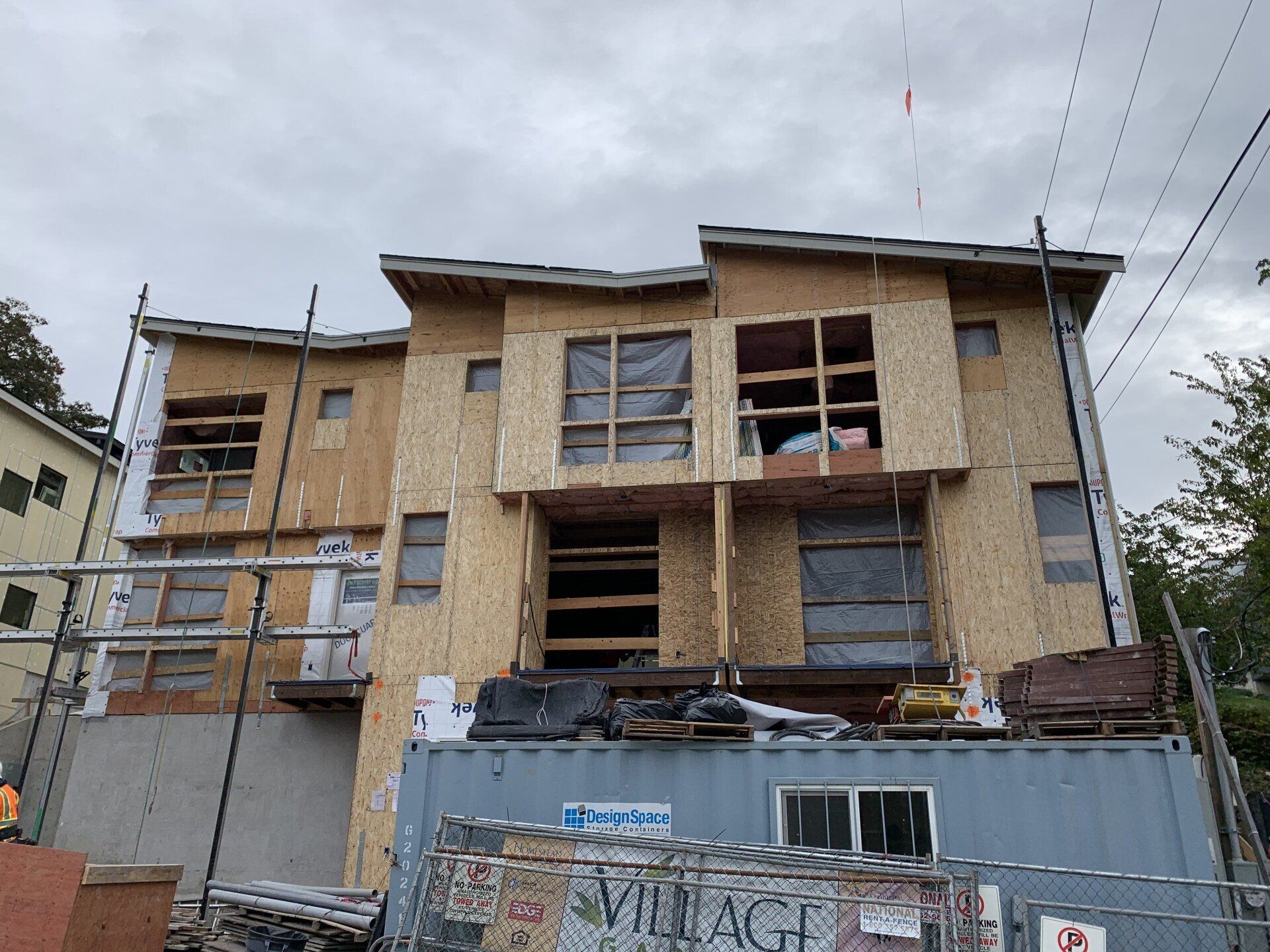 A building under construction with a sign that says village
