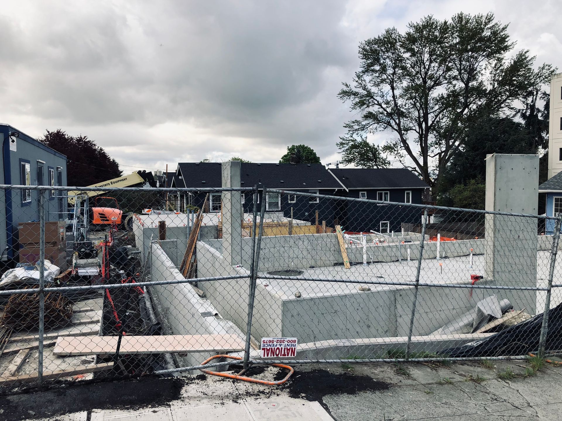 A construction site with a chain link fence surrounding it.