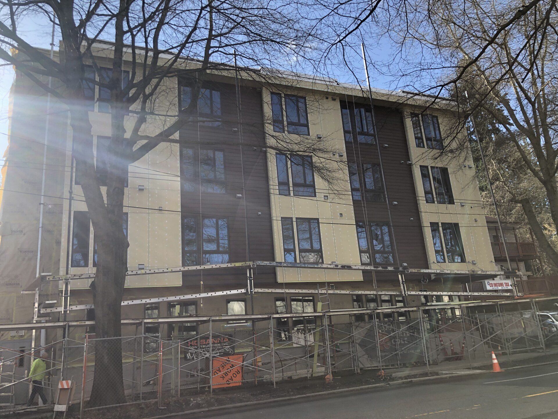 A large building is being built on the side of the road.