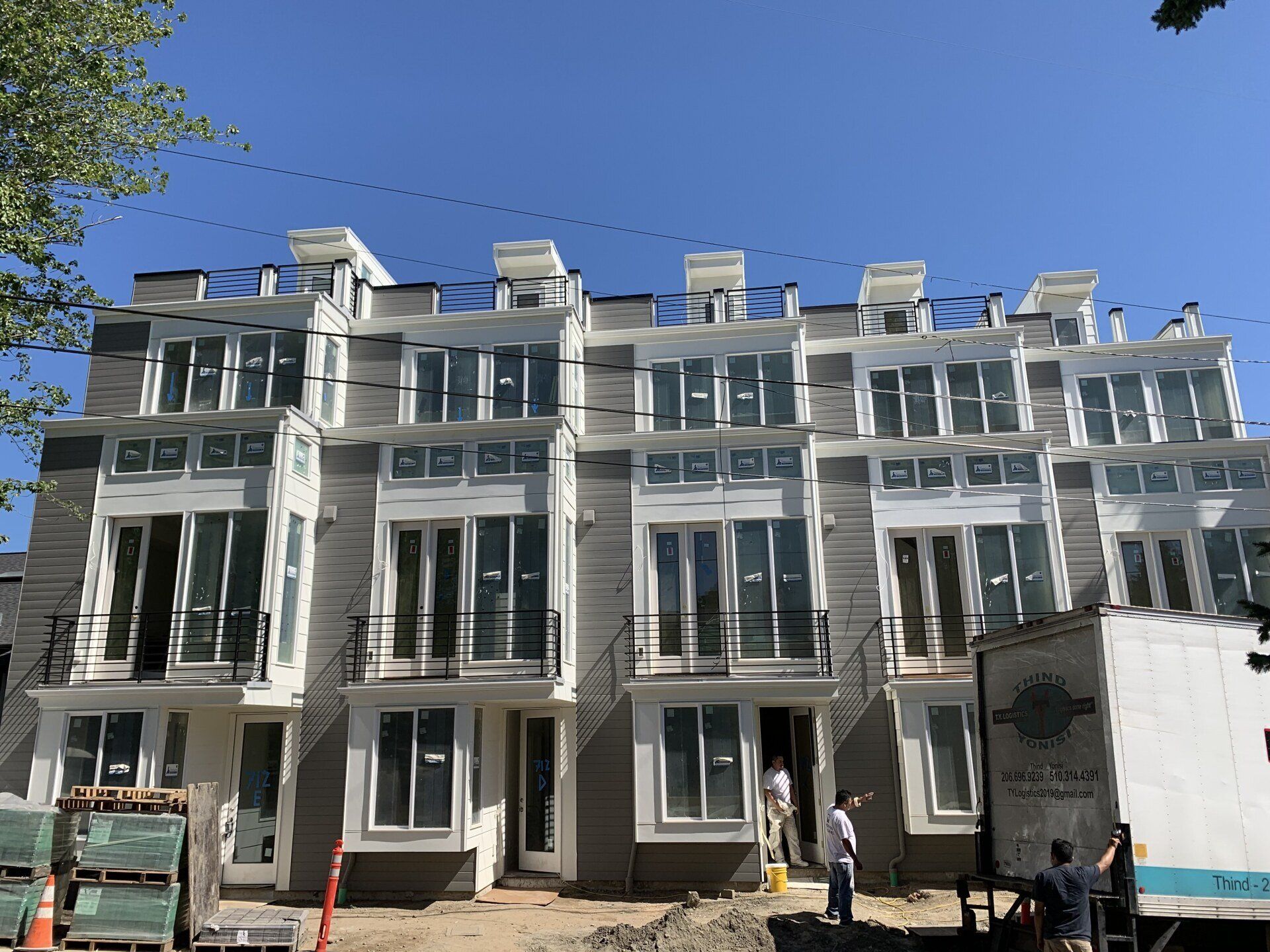 A row of houses are being built in a city.