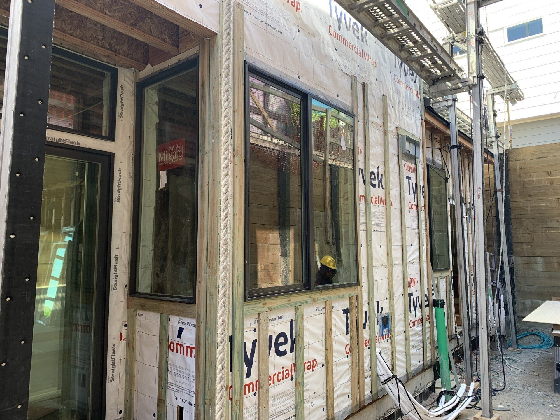 A building under construction with a lot of windows and scaffolding.