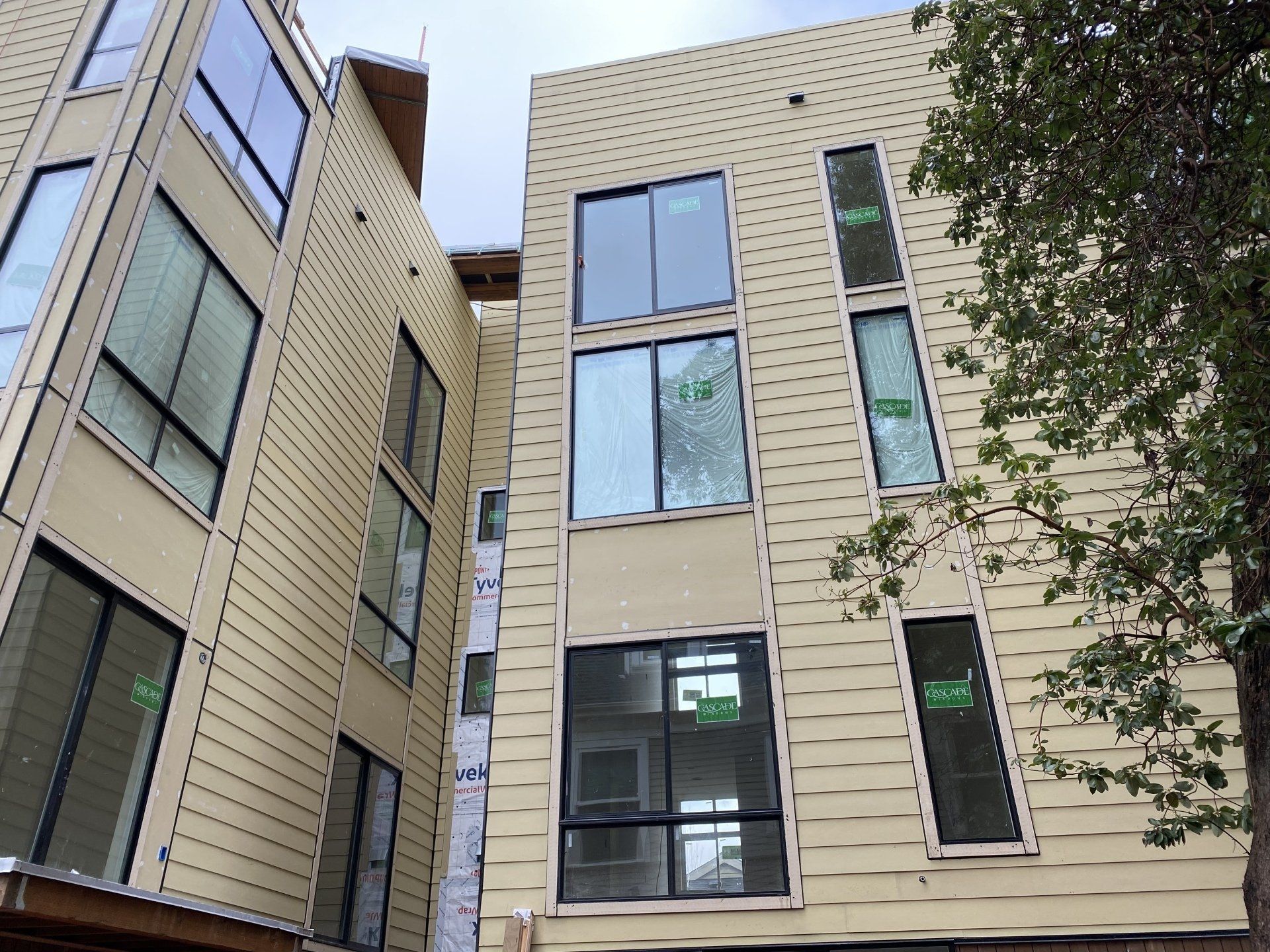 A building with a lot of windows and a tree in front of it