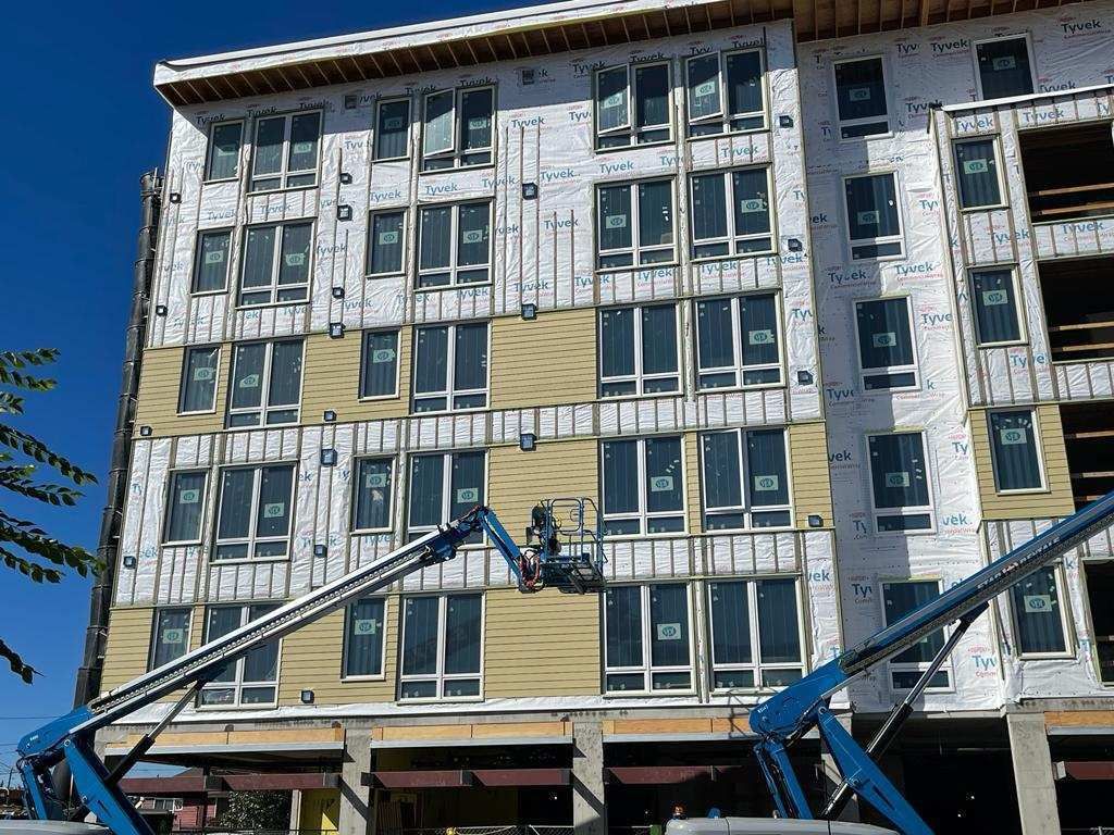 A large building with a lot of windows is being built