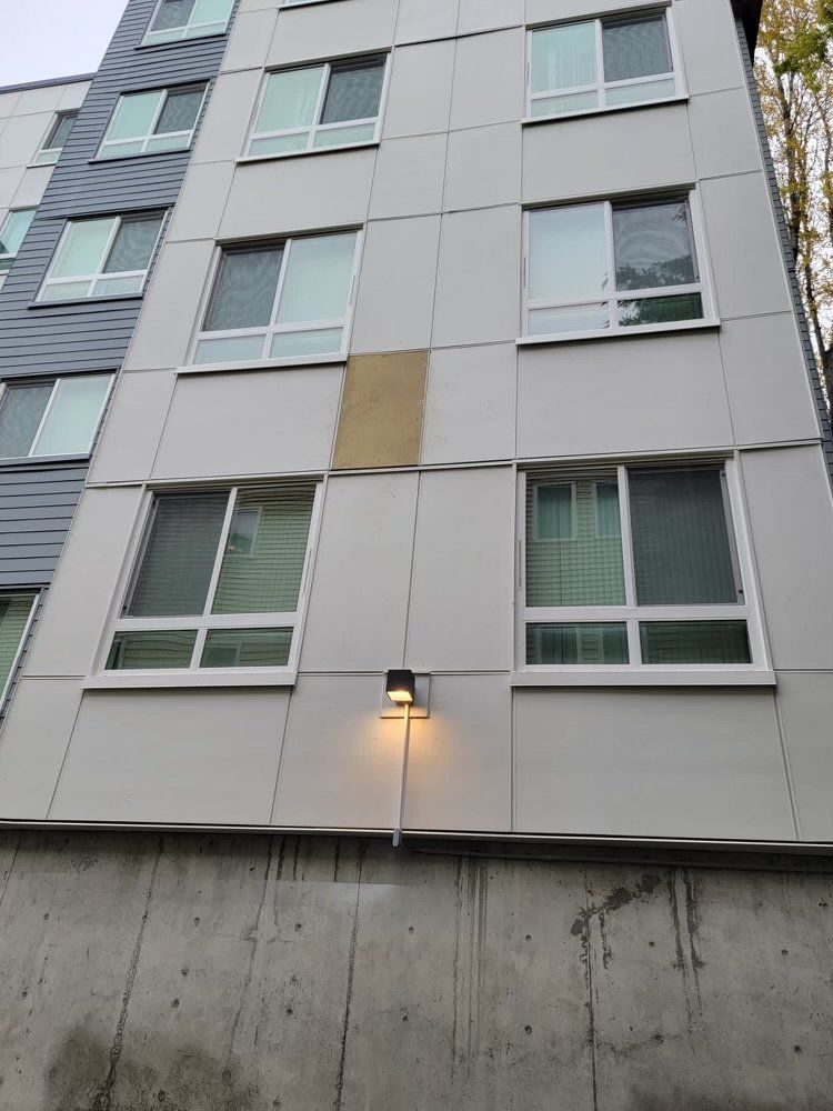 A building with a lot of windows and a light on the side