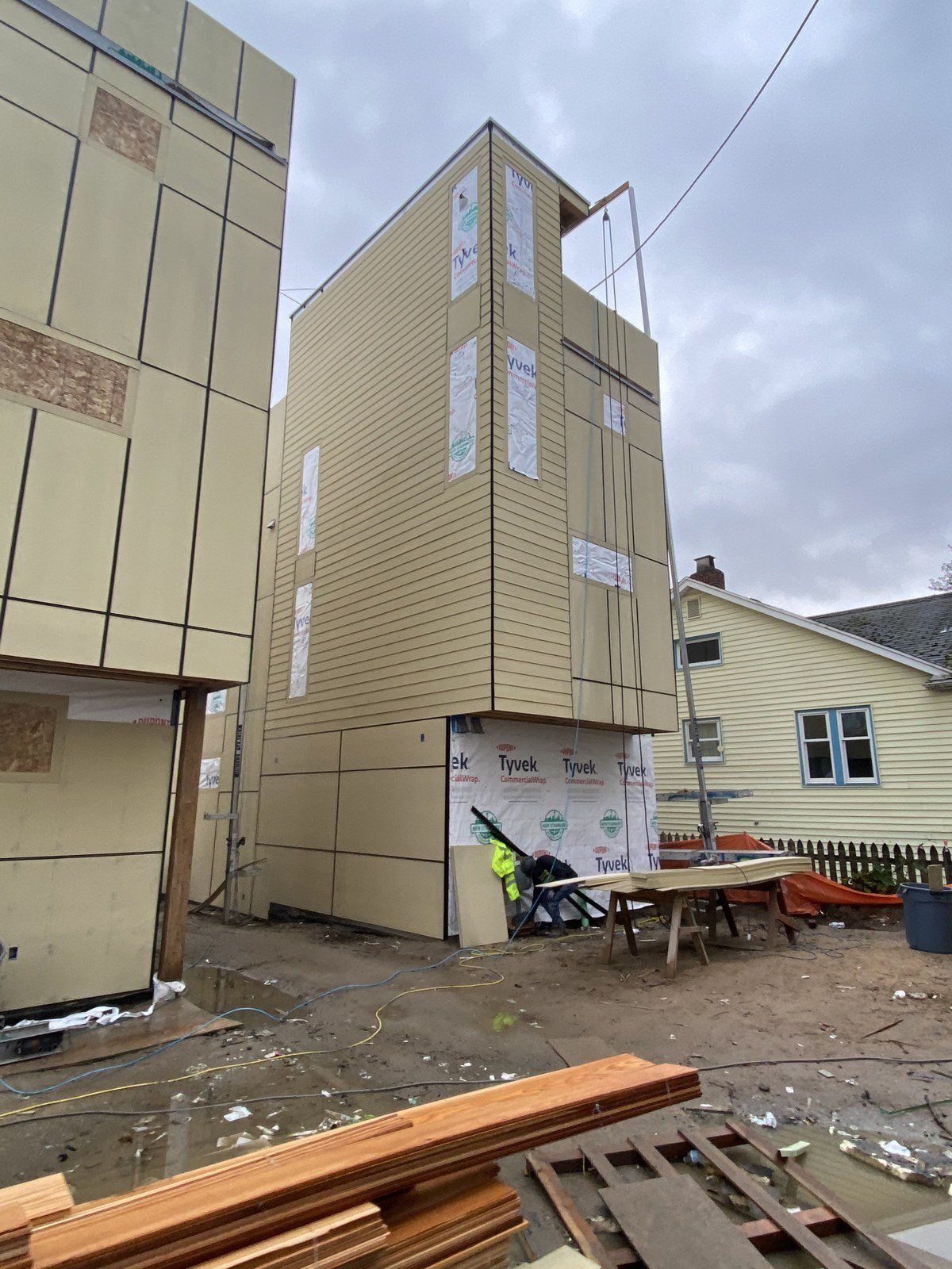 A large building is being built next to a smaller building.