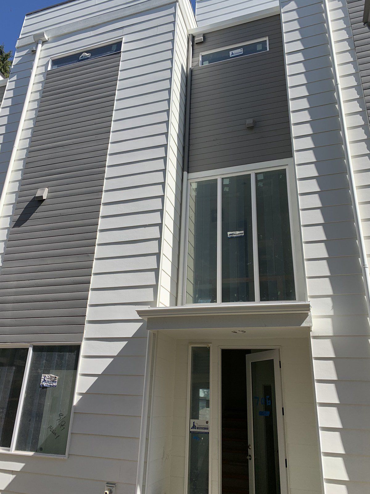 A white building with a lot of windows and a door