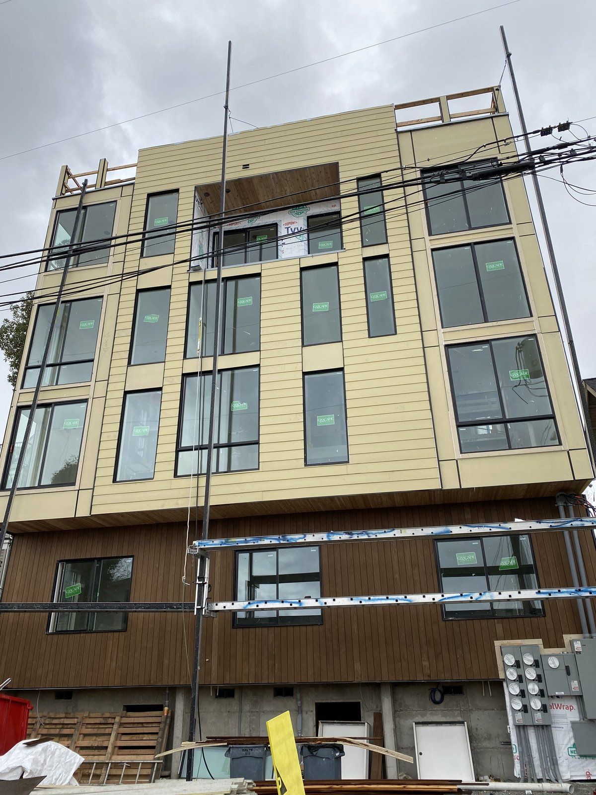 A large building with a lot of windows is under construction.