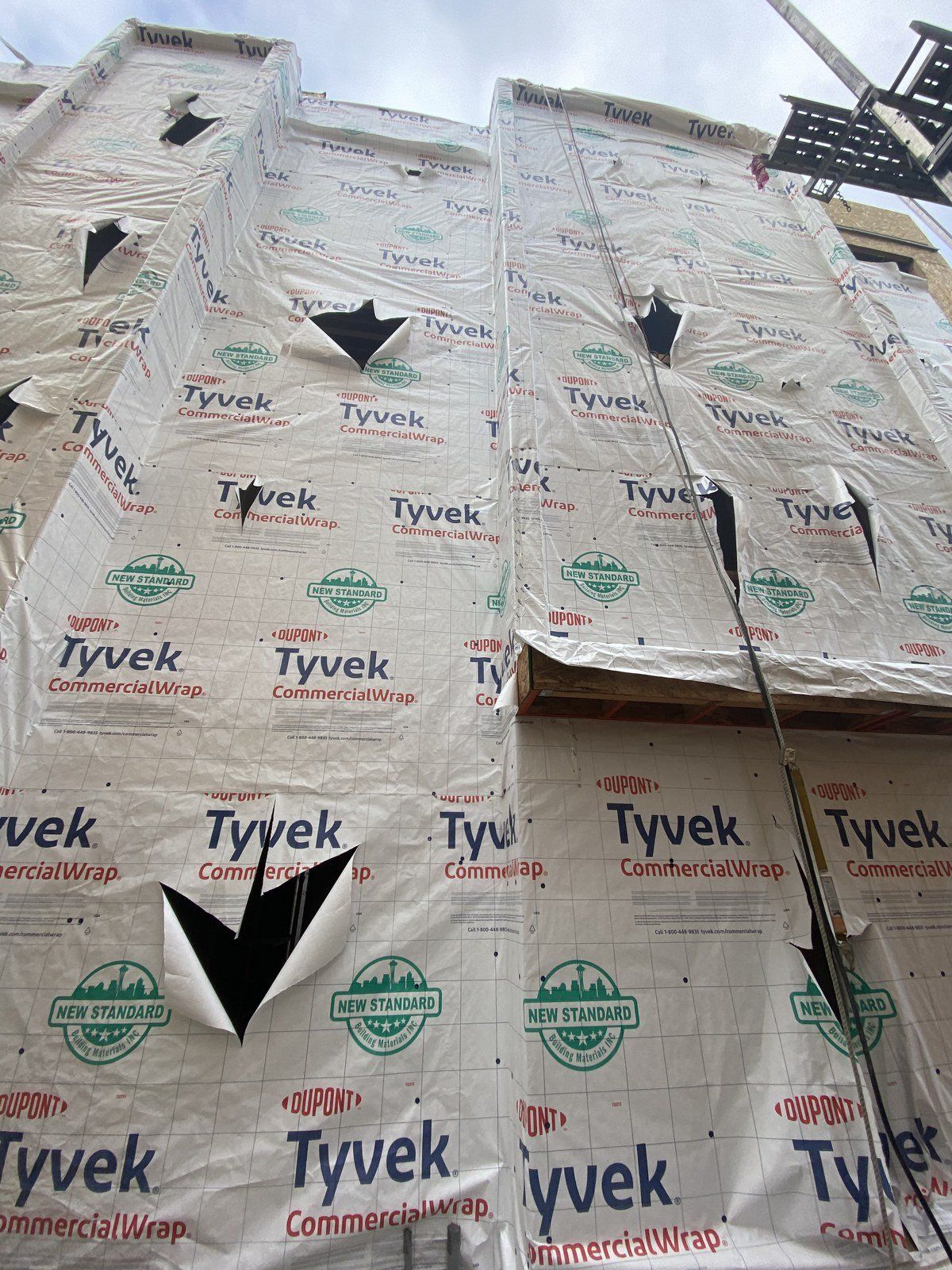 A building with a lot of tyvek insulation on it