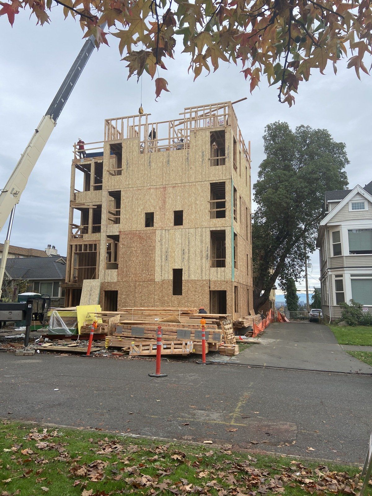A building under construction with a crane in front of it