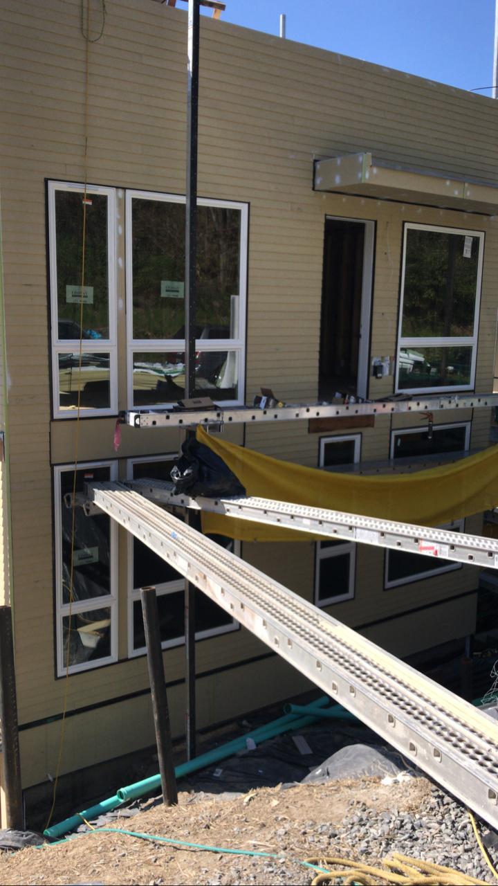 A house with a lot of windows is being built