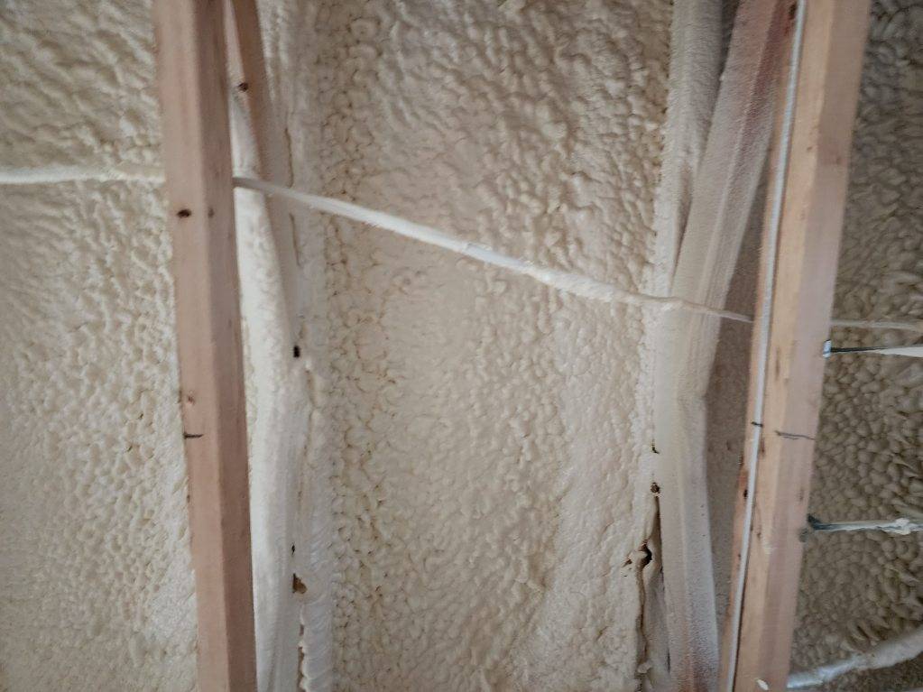 A wall with a lot of foam on it and a wooden frame.