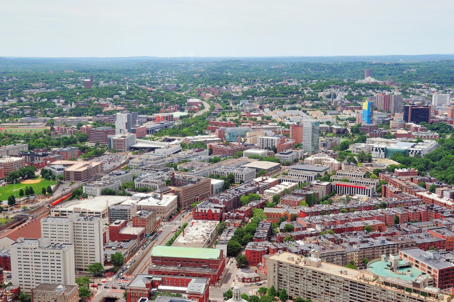 An aerial view of a city with lots of buildings and trees