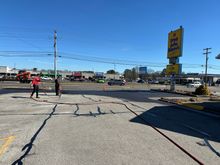 A road with a yellow sign that says roadside assistance