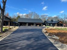 A large house with a large driveway leading to it.