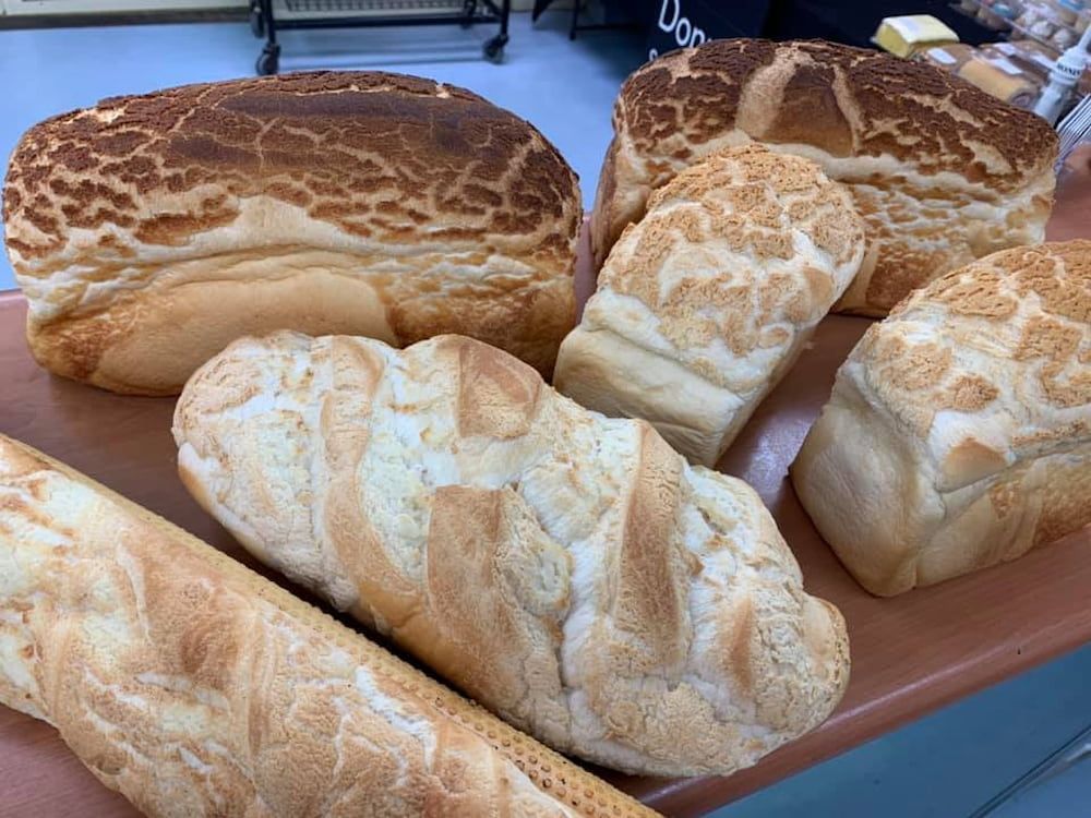 A Bunch Of Different Types Of Bread Are Sitting On A Table — Cedar Park Bakehouse in Taranganba, QLD