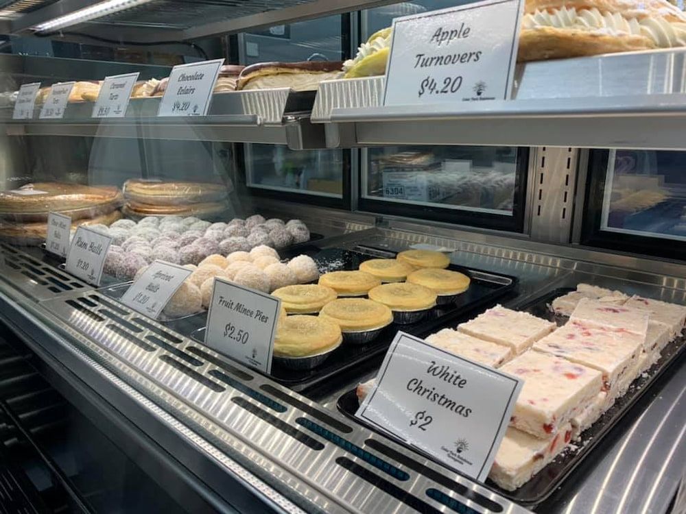 A Display Case Filled With A Variety Of Pastries And Desserts — Cedar Park Bakehouse in Taranganba, QLD