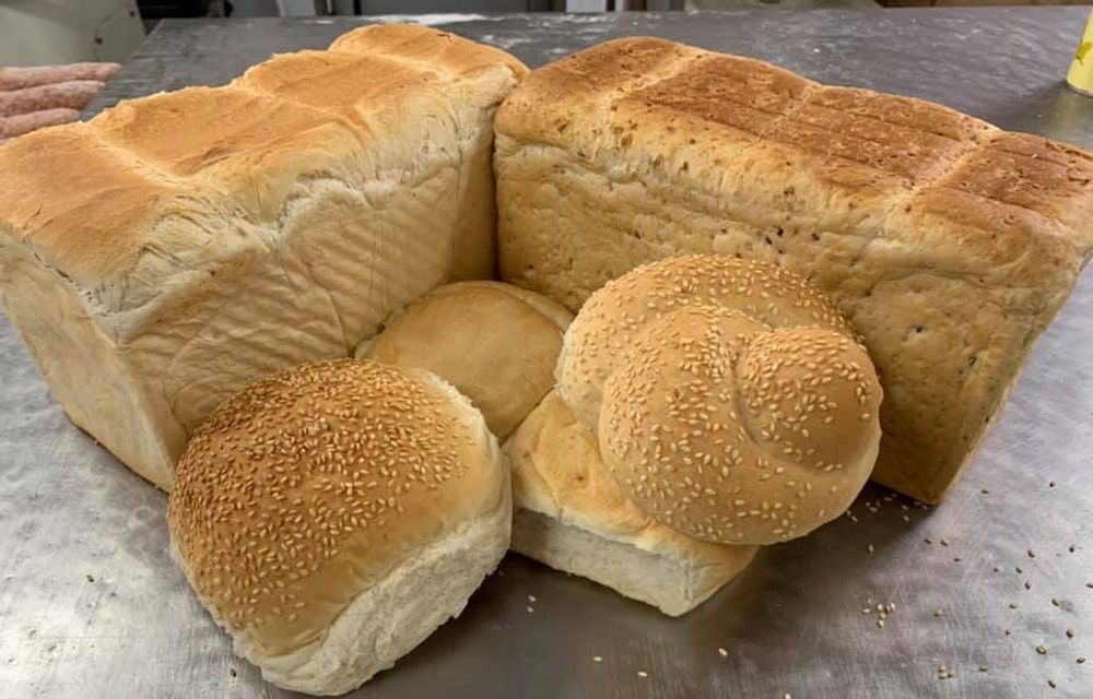 A Bunch Of Bread And Rolls Are Sitting On A Table — Cedar Park Bakehouse in Taranganba, QLD