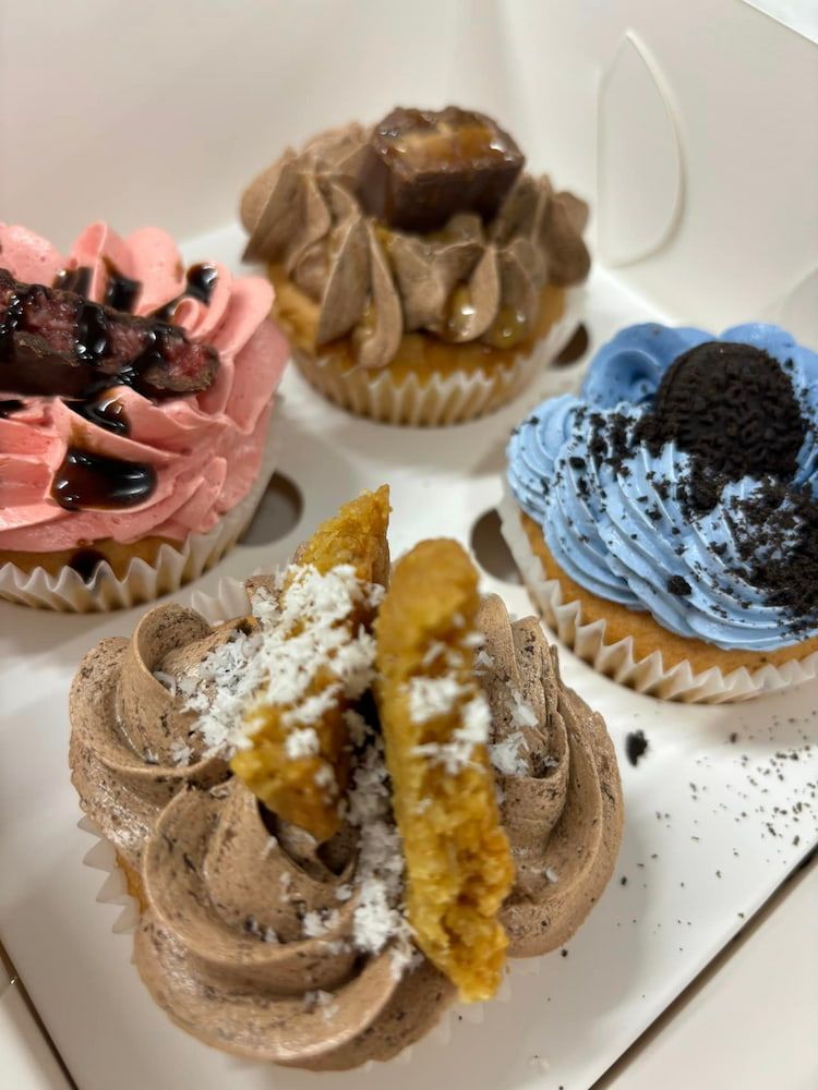 Three Cupcakes In A Box With One Missing A Bite — Cedar Park Bakehouse in Taranganba, QLD