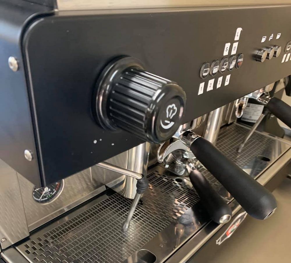 A Coffee Machine With A Black Handle — Cedar Park Bakehouse in Taranganba, QLD