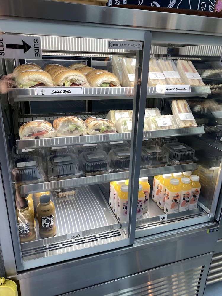 A Display Case Filled With Sandwiches And Drinks In A Restaurant β Cedar Park Bakehouse in Taranganba, QLD