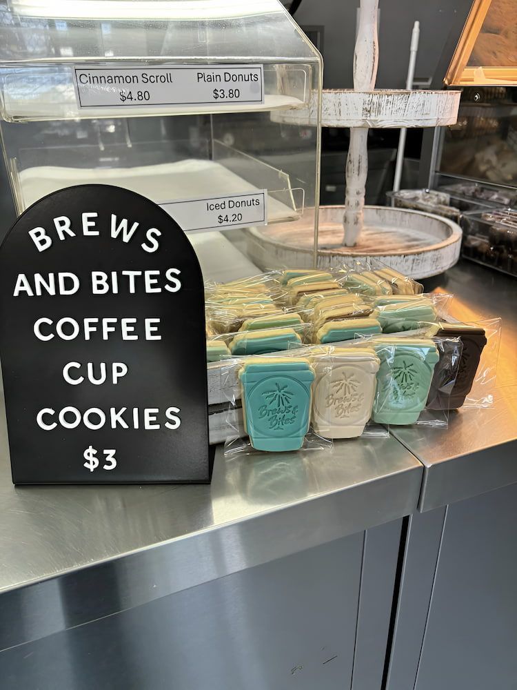 A Display Case Filled With Cookies And A Sign That Says It — Cedar Park Bakehouse in Taranganba, QLD