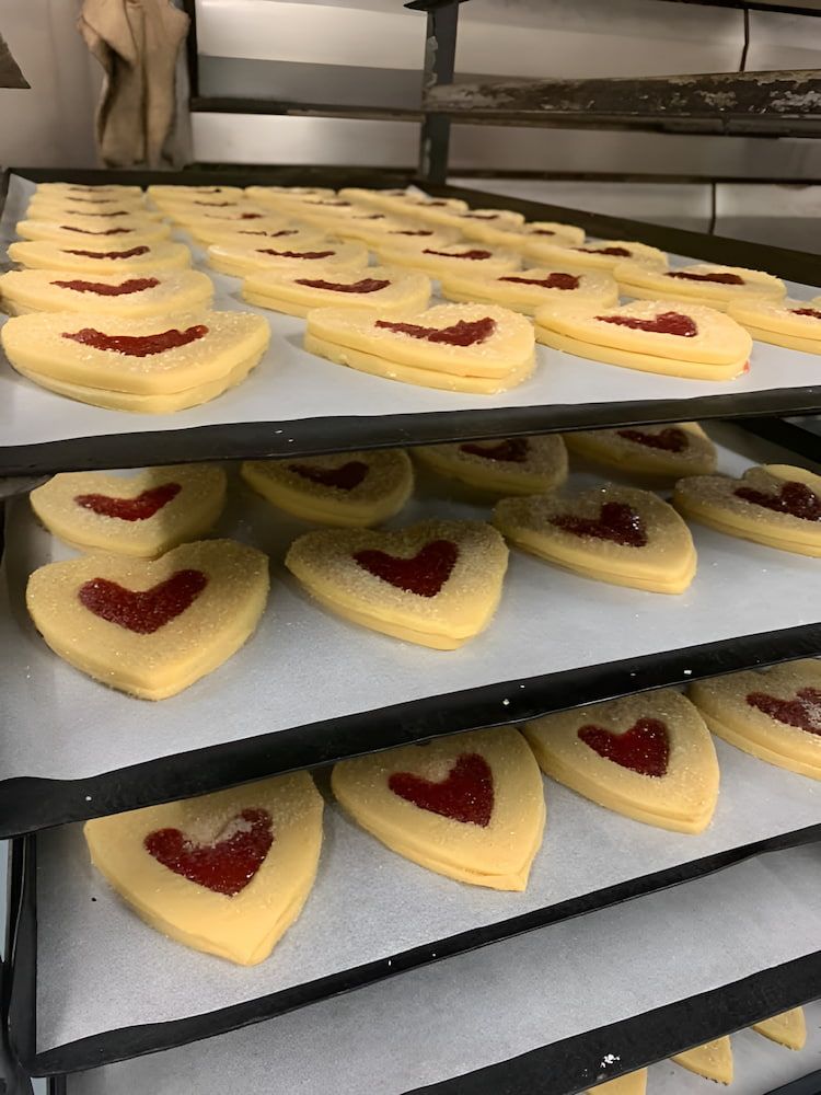 A Bunch Of Heart Shaped Cookies Are Sitting On A Tray — Cedar Park Bakehouse in Taranganba, QLD