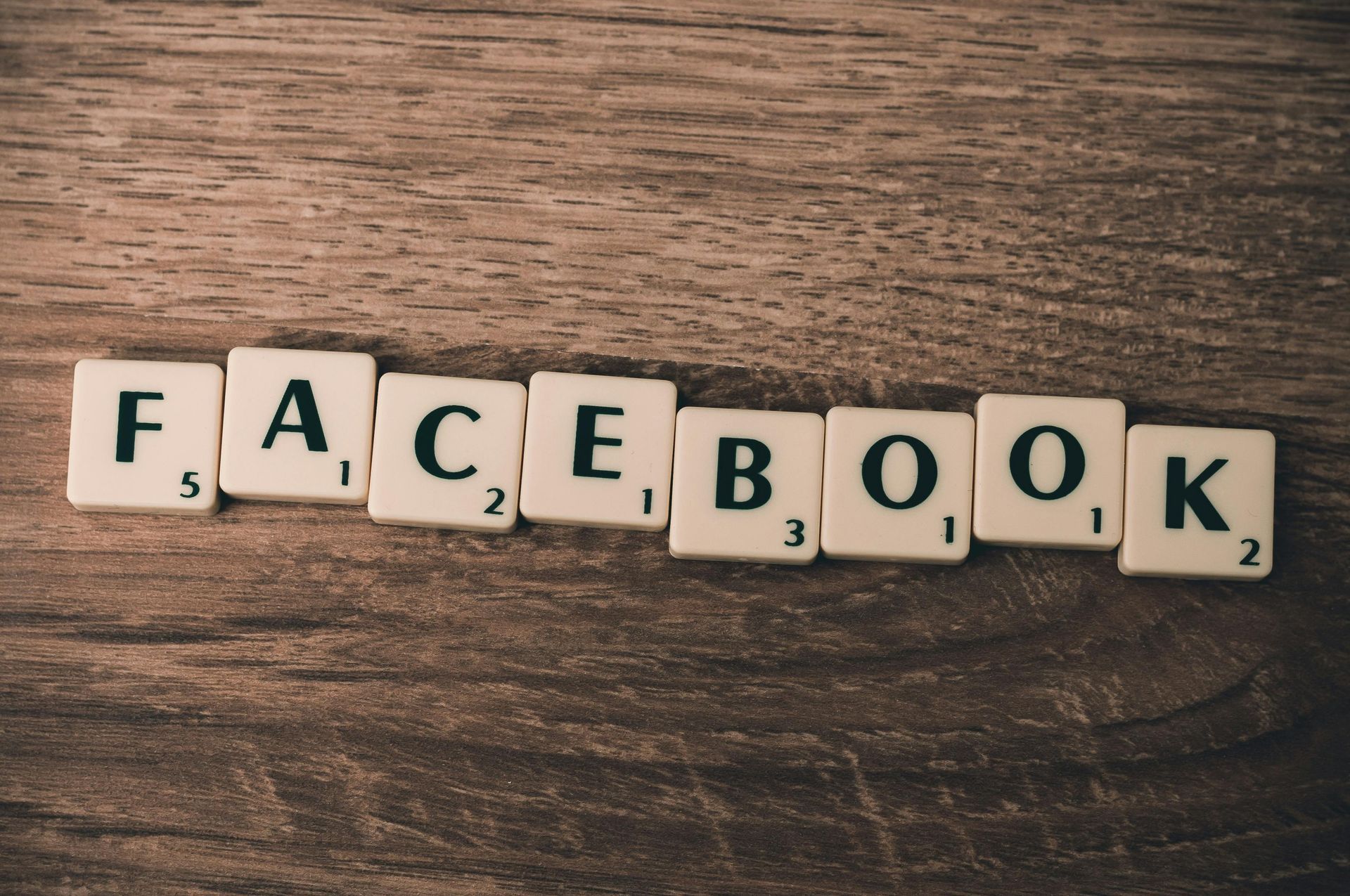 Scrabble tiles spell out the word facebook on a wooden table