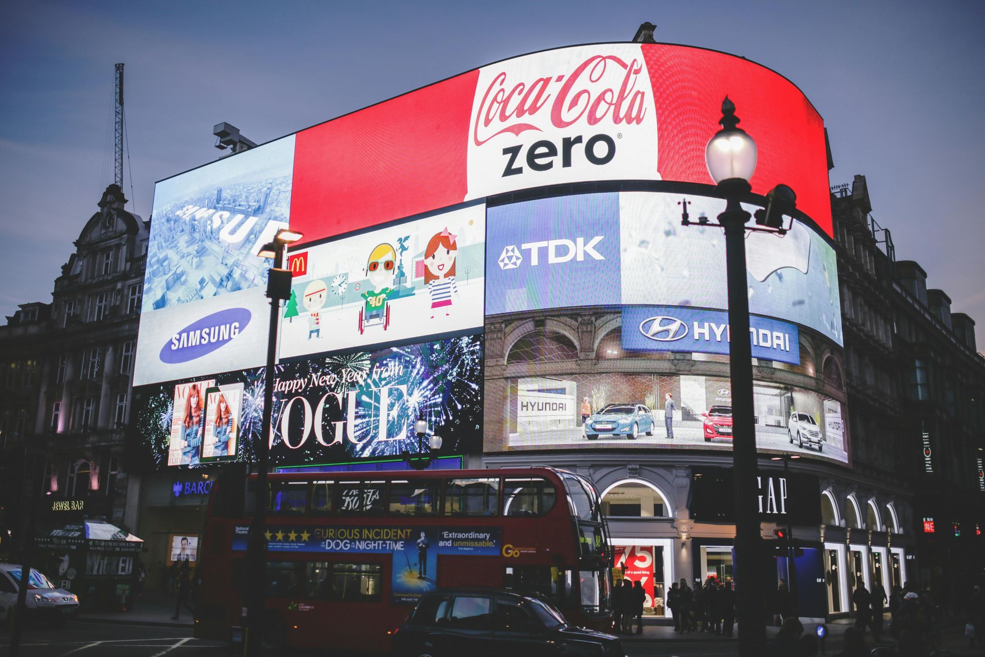 A large billboard on the side of a building that says coca cola zero