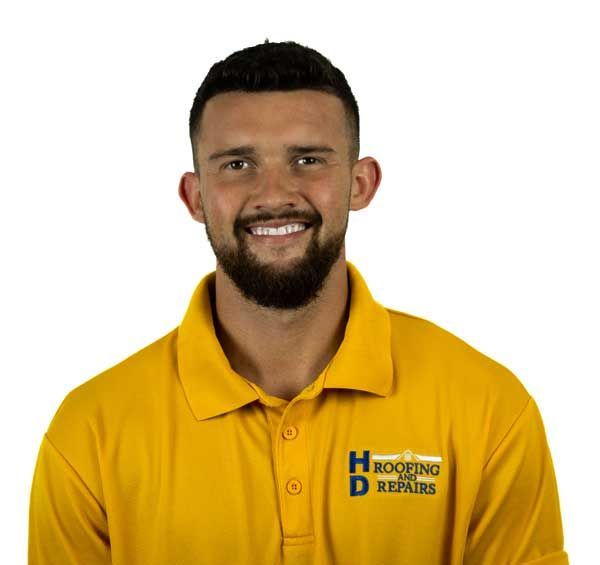 Man with beard wearing yellow polo shirt with 