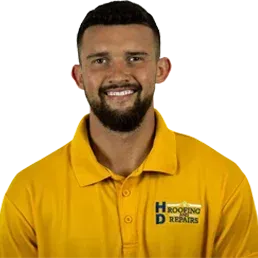 Man in yellow polo smiling, logo on shirt says "HD Roofing & Repairs."