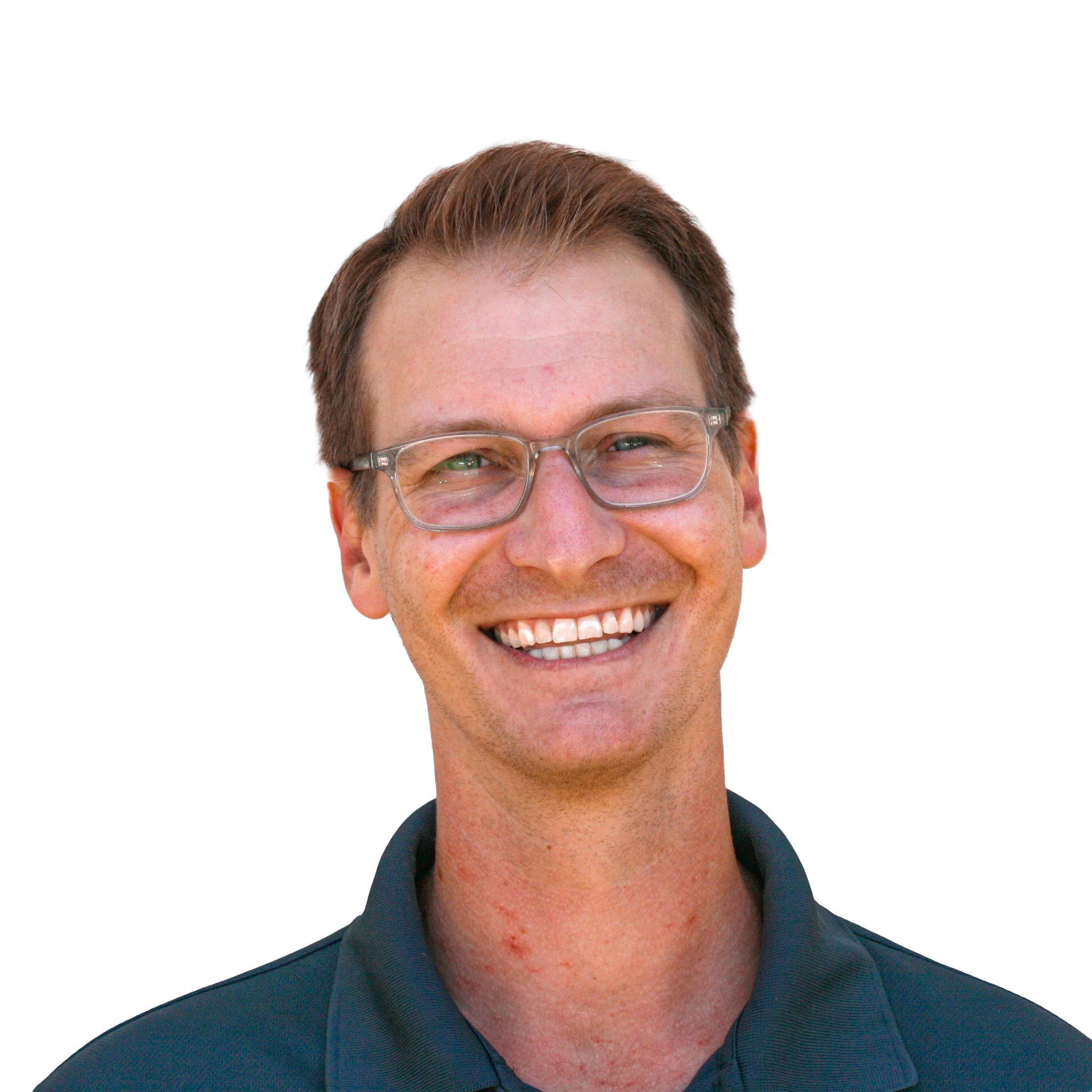 Man wearing glasses smiling. He's wearing a dark green shirt. Yellow background.