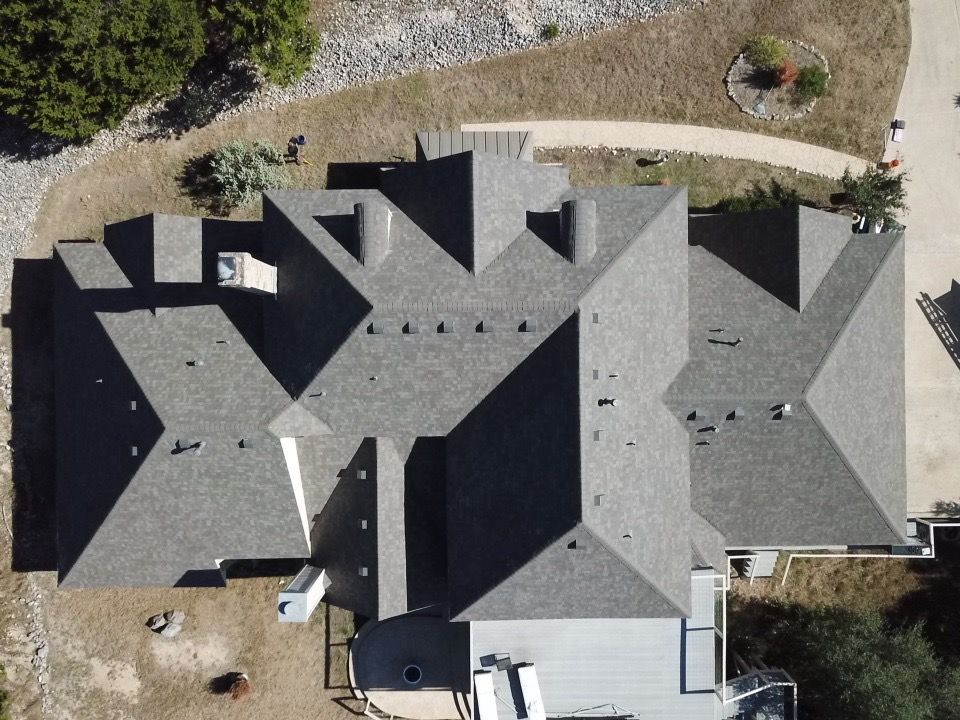 Aerial view of a completed residential roof by HD Roofing and Repairs for an Austin, TX homeowner af