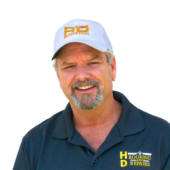Man wearing a baseball cap with "HD Roofing and Repairs" logo, smiling, yellow background.