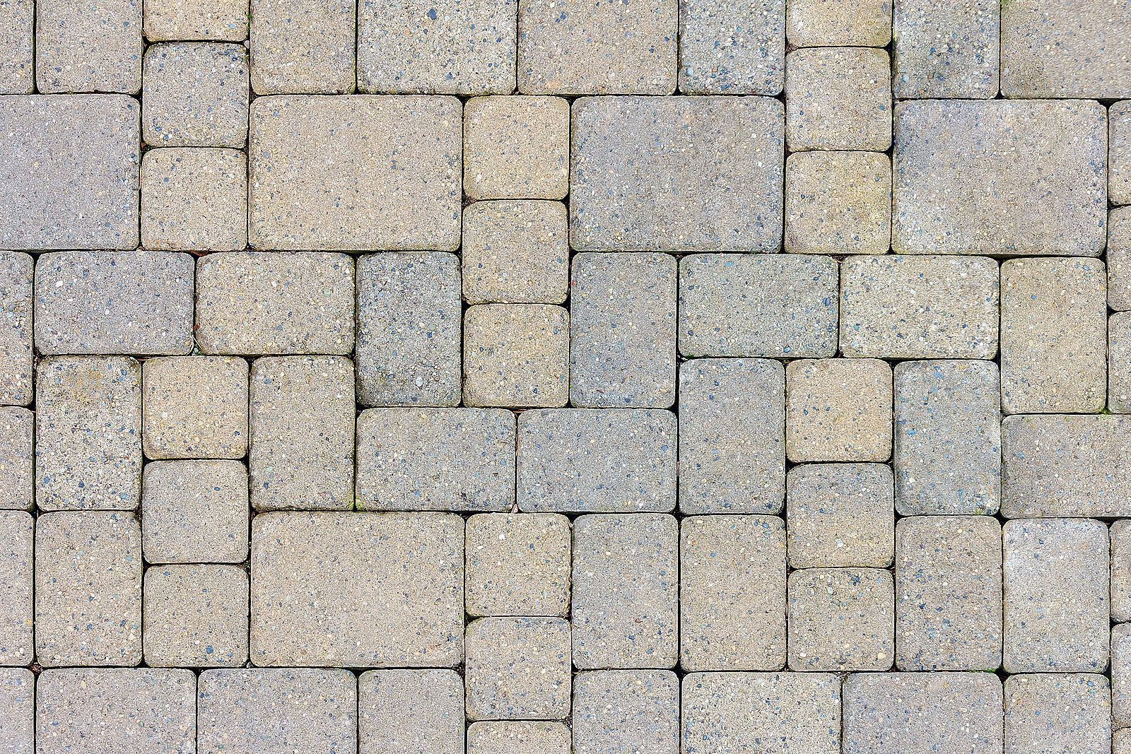 A close up of a brick walkway with a geometric pattern.