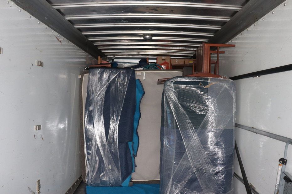 The inside of a moving truck is covered in plastic bubble wrap.