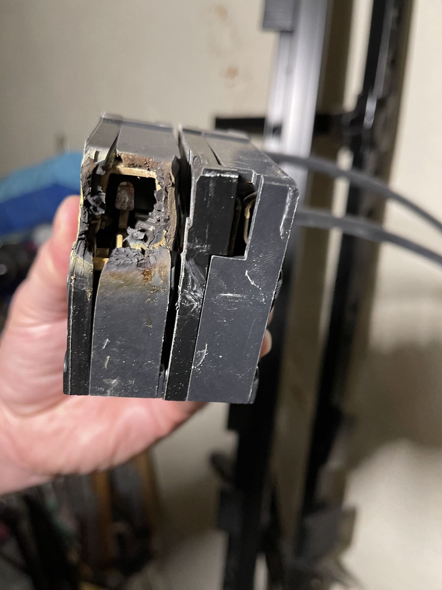 A person is holding a piece of metal in their hand.