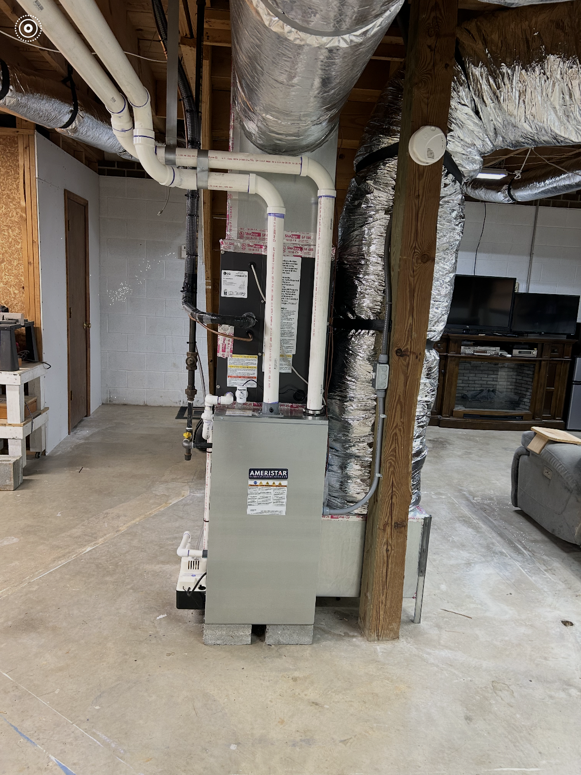 HVAC service technician measuring static pressure across a high-MERV air filter in Liberty, NC.