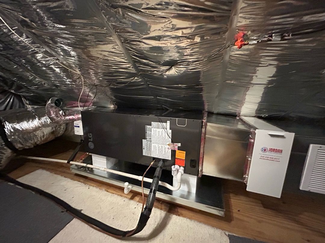 HVAC installation technician mounting an active whole-home air scrubber into supply ductwork in Ashe