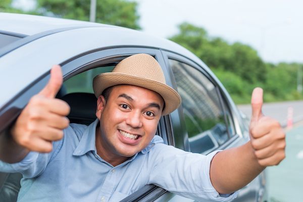 man in a car gives 2 thumbs up to his Southern MD Road Trip.