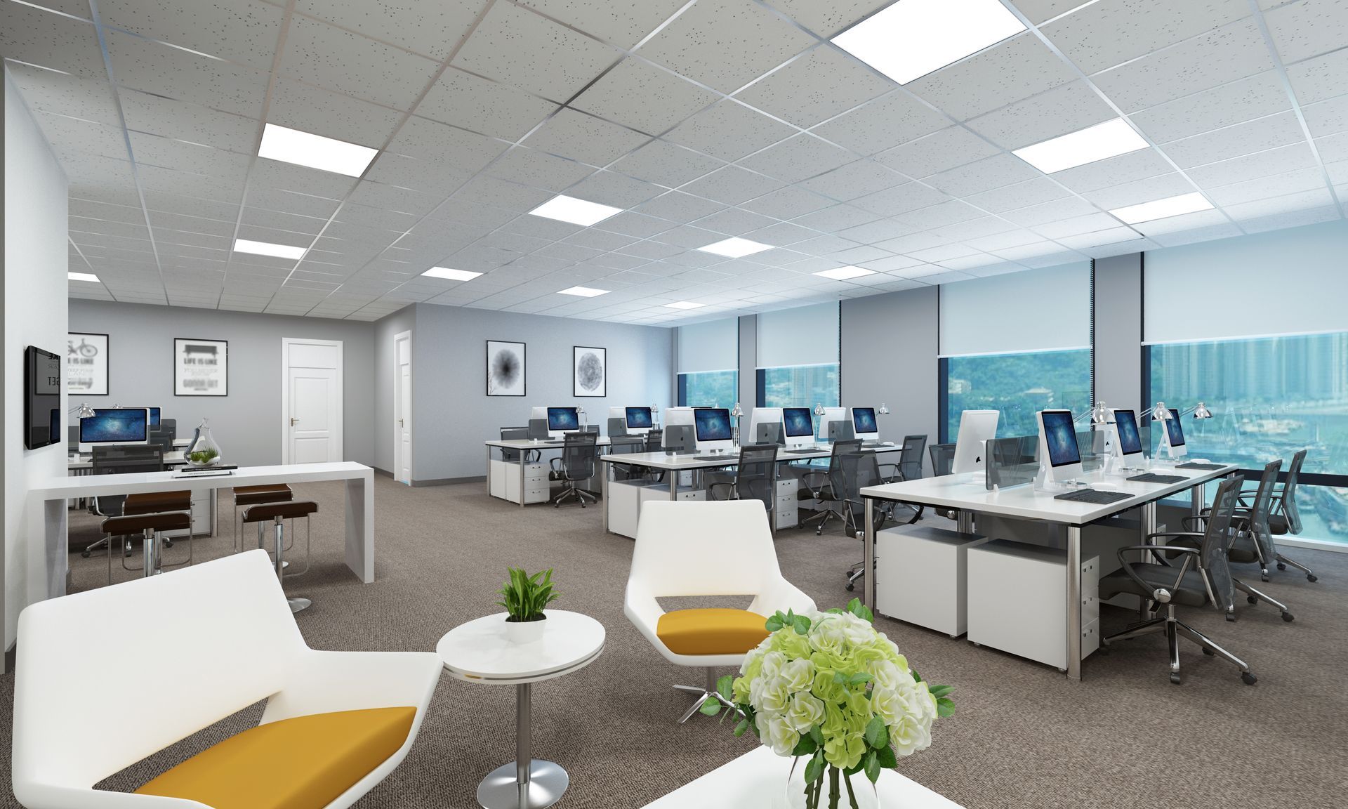 Bright open-plan office with desks, computers, white chairs, and large windows.