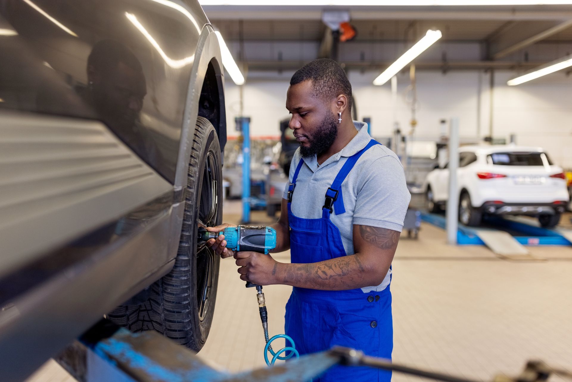 A mechanic is performing a tire repair, showcasing the tools and equipment used for the service.