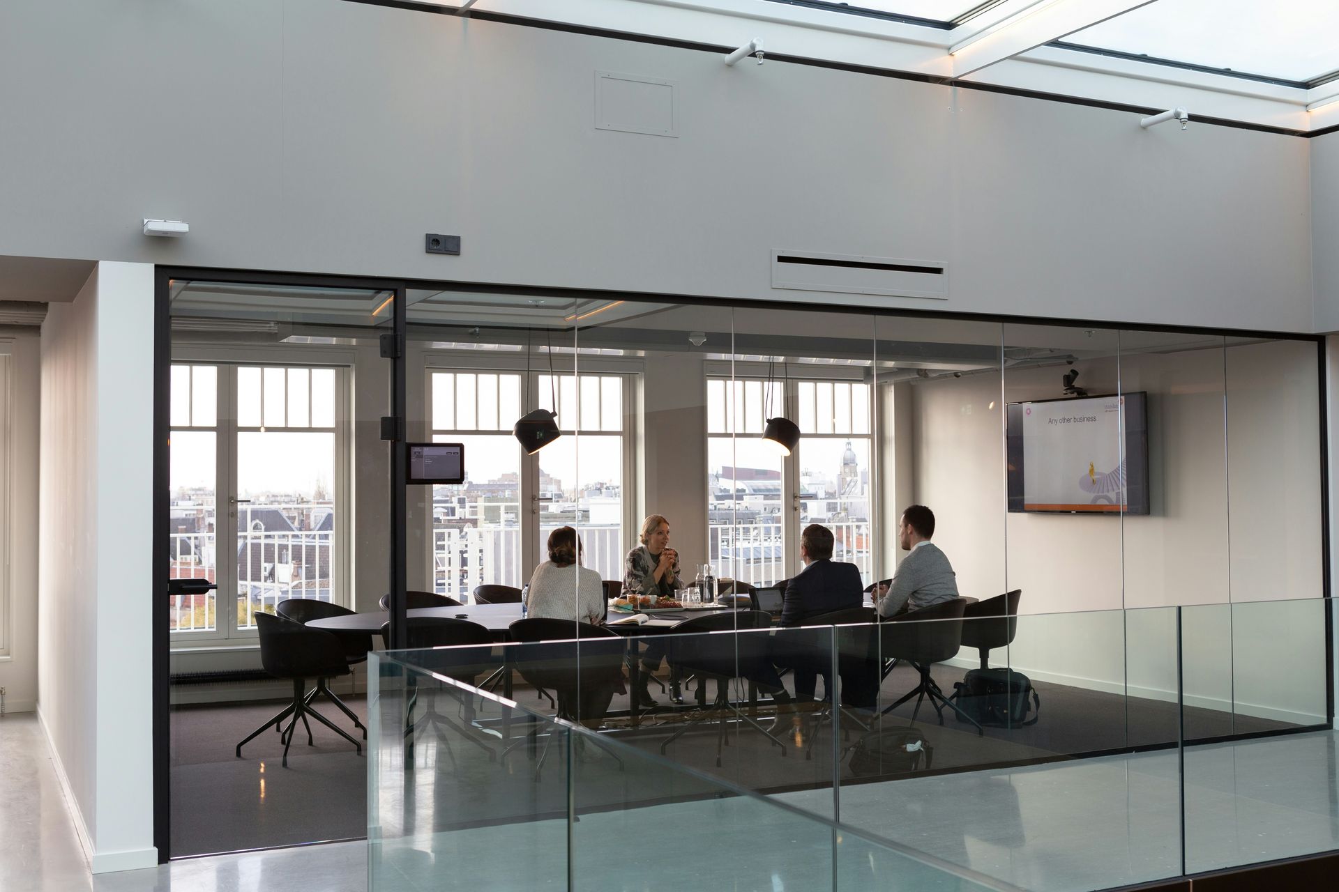 A group of people are sitting around a table in a conference room.