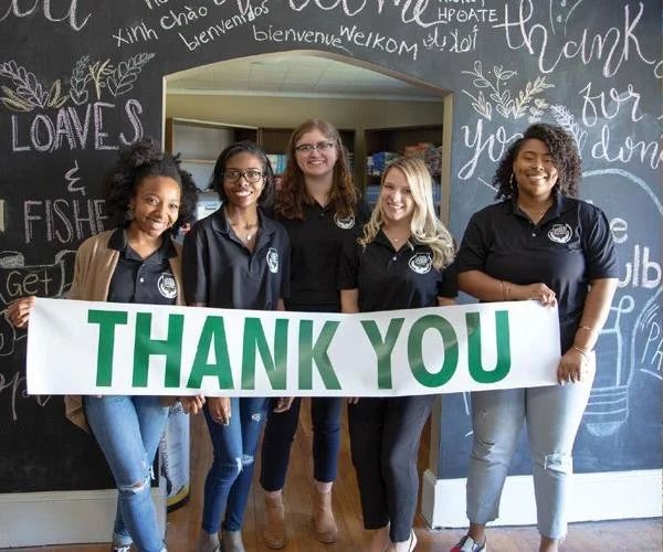 Five people holding a 