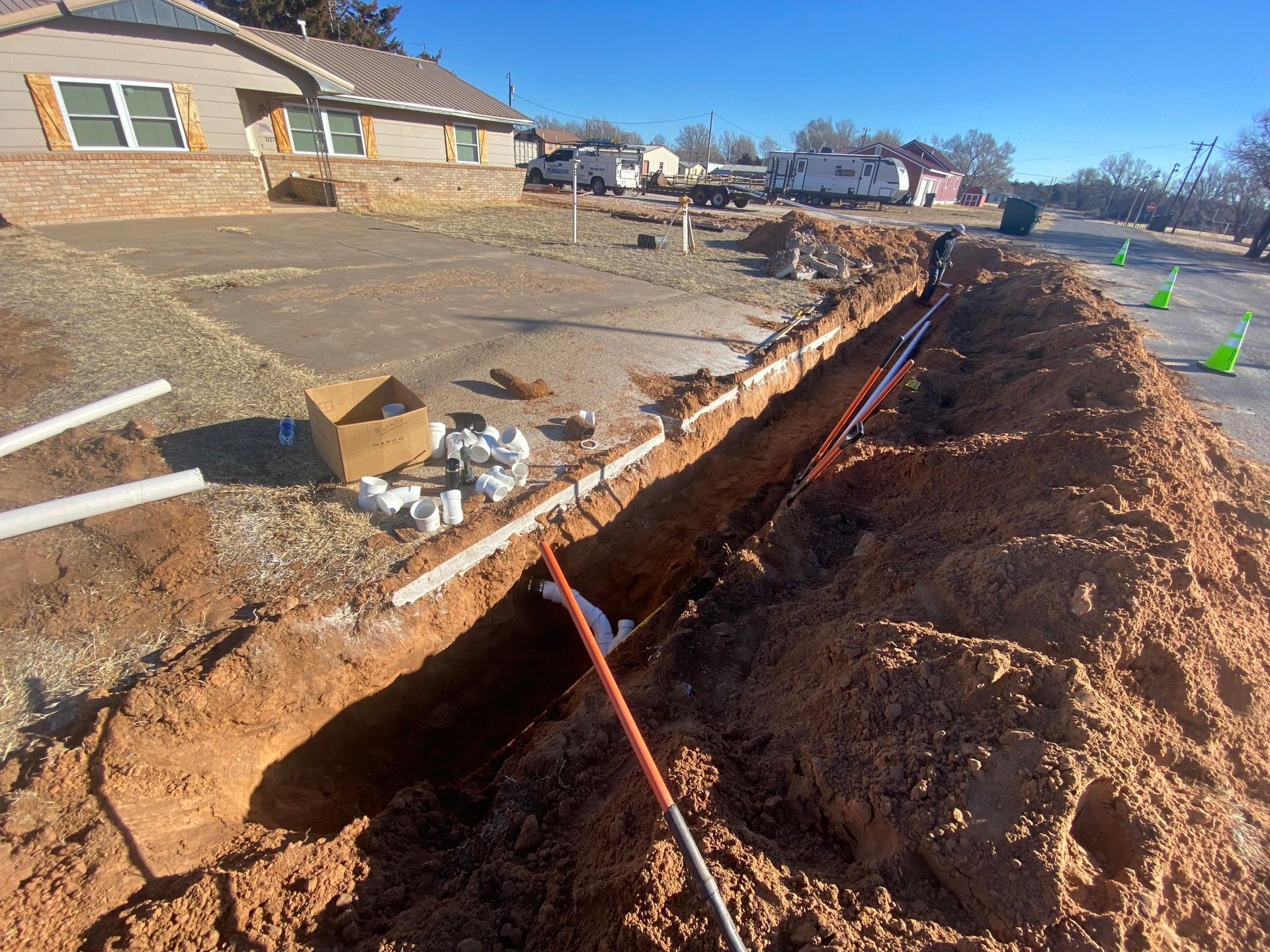 A large pile of dirt is sitting in front of a house.