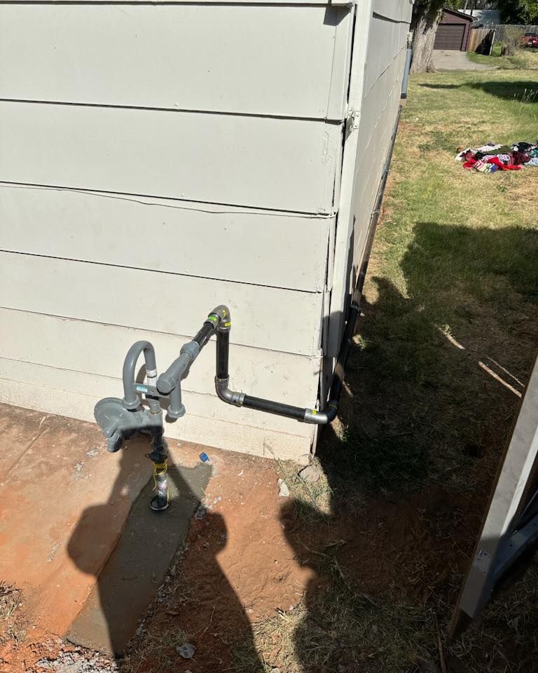 A gas meter is attached to the side of a house.