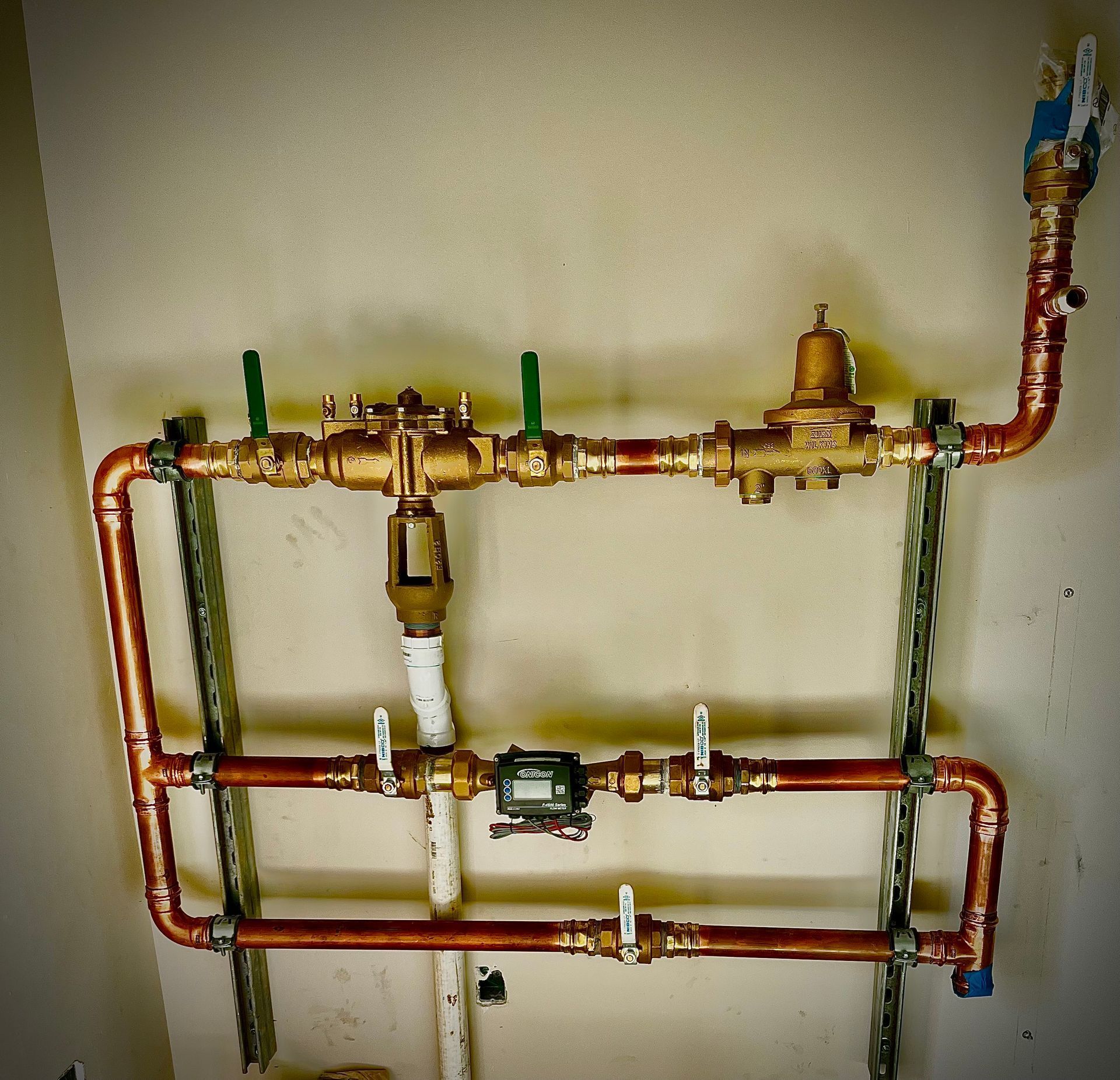 A copper pipe with a meter attached to it