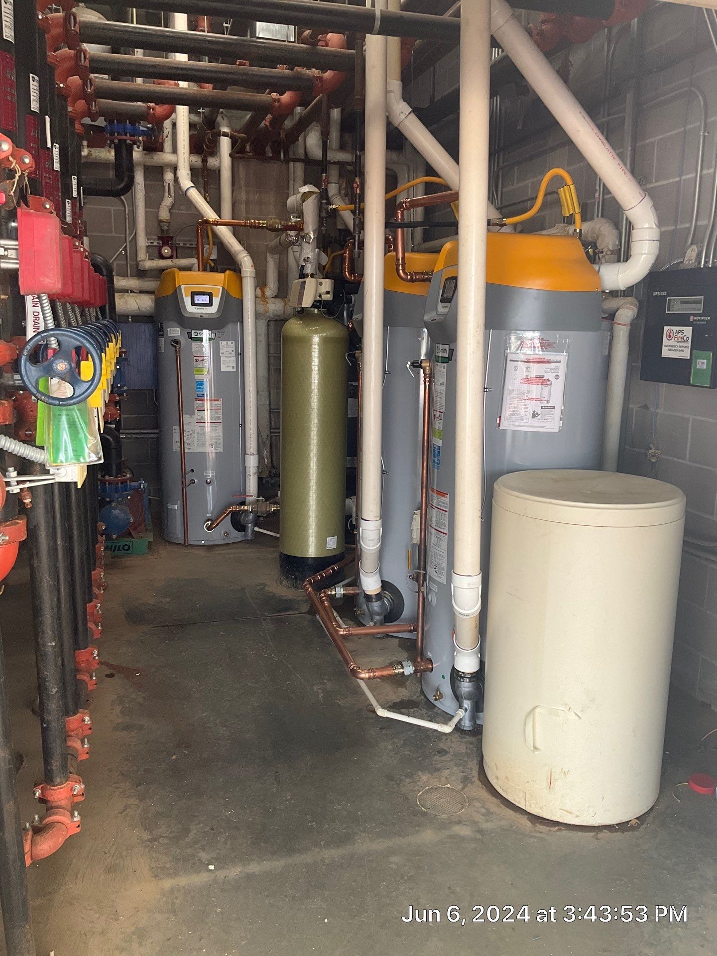 A room with a lot of pipes and water heaters