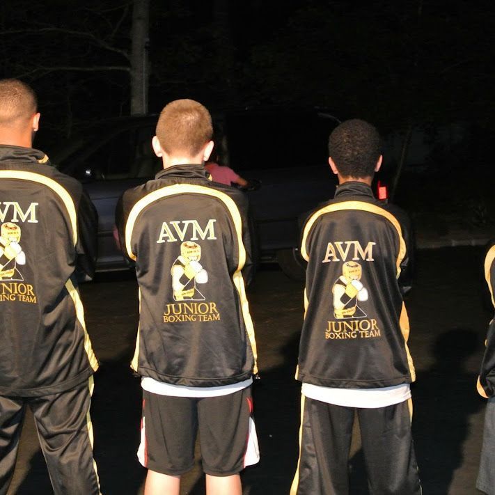 A group of boys wearing jackets that say avm junior boxing team