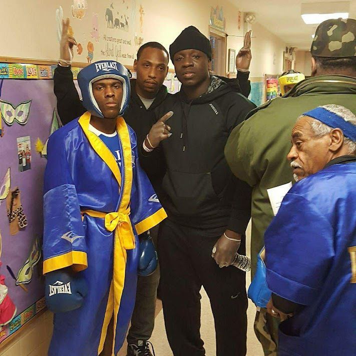 A man in a blue robe has everlast boxing gloves on